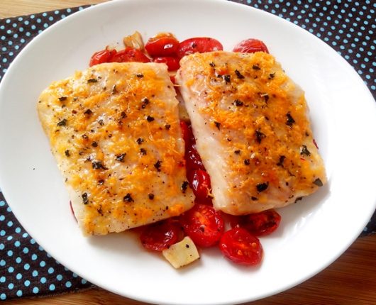 Filé de peixe com queijo e manjericão sobre tomatinhos assados