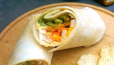 Wrap de frango com cenoura, alface, milho e molho de mostarda
